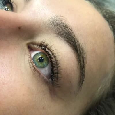 lady with green eyes having classic lash estensions applied by lashesthetica